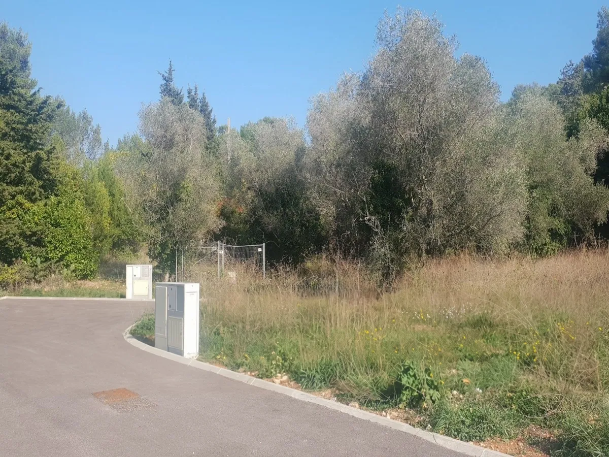 The subdivision's new road and utility cabinets at the boundary